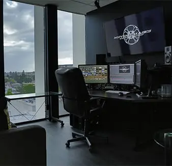 office chair and two monitors by the window